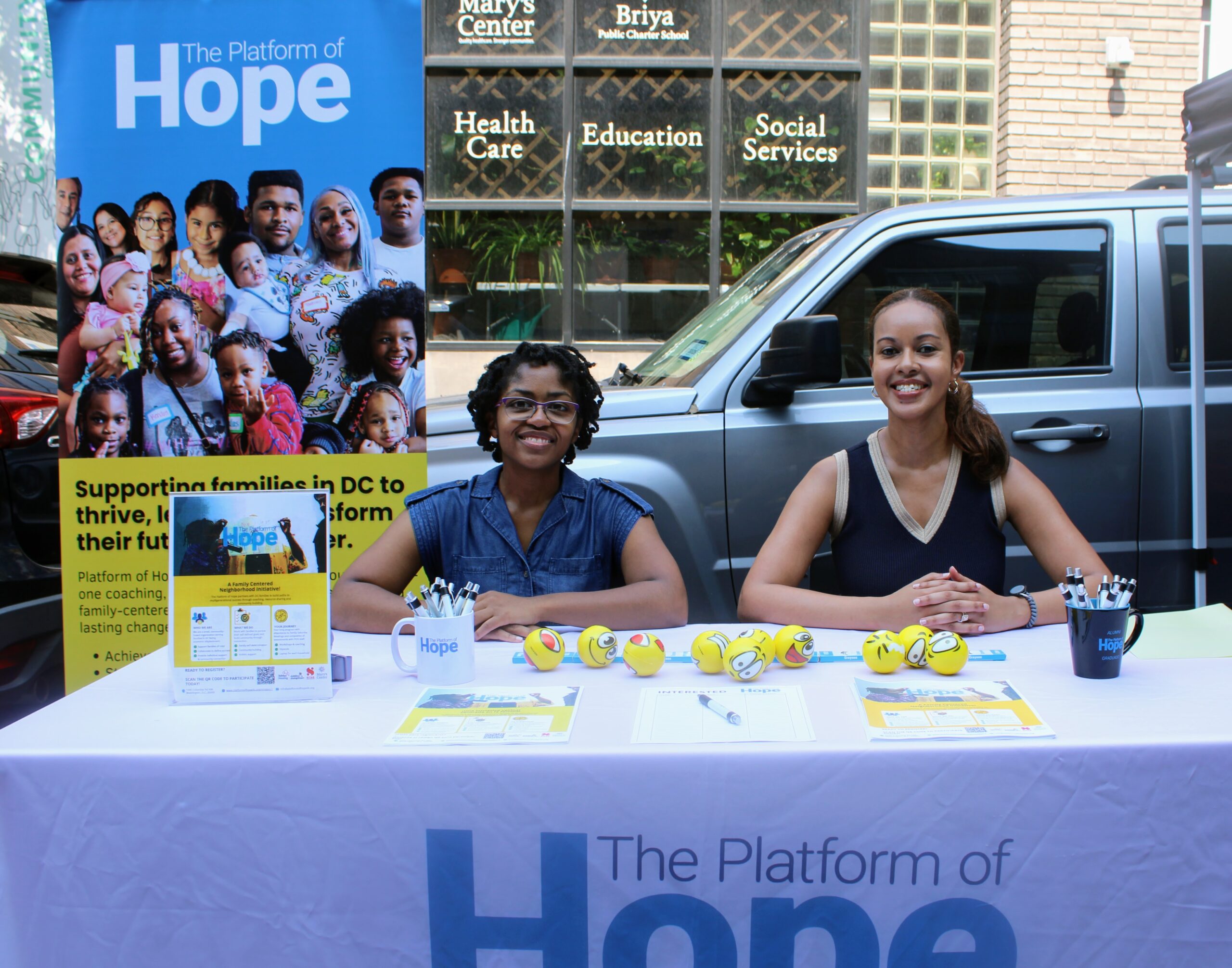 Platform of Hope staff welcoming neighbors at a community information booth